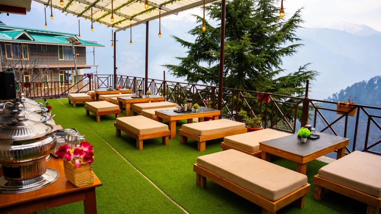 Outdoor lounge deck at Kanyal Heights overlooking the Manali valley