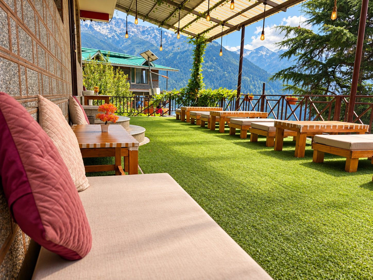 Open seating area with turf lawn and mountain views at Kanyal Heights